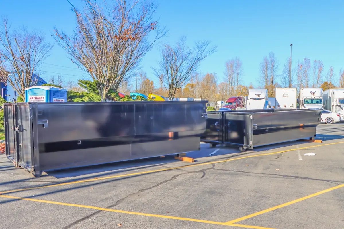 Professional dumpster rental service with roll-off container on residential driveway in Wyoming